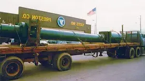 Truck with large cylinder in front of sign that reads "Yates Ind. Preston Co."